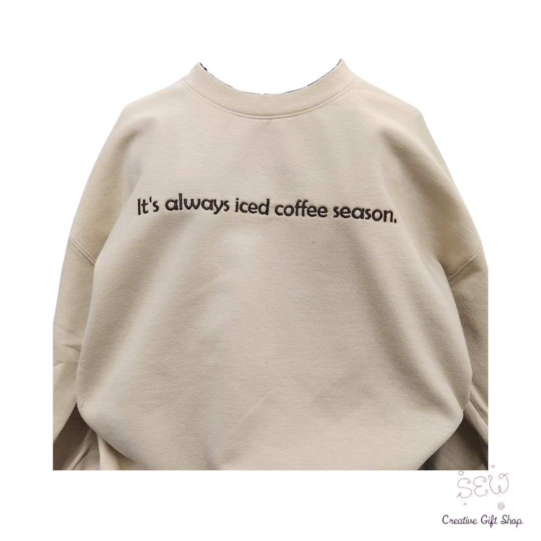 It's always iced coffee season. Sand color Embroidered Adult Sweatshirt