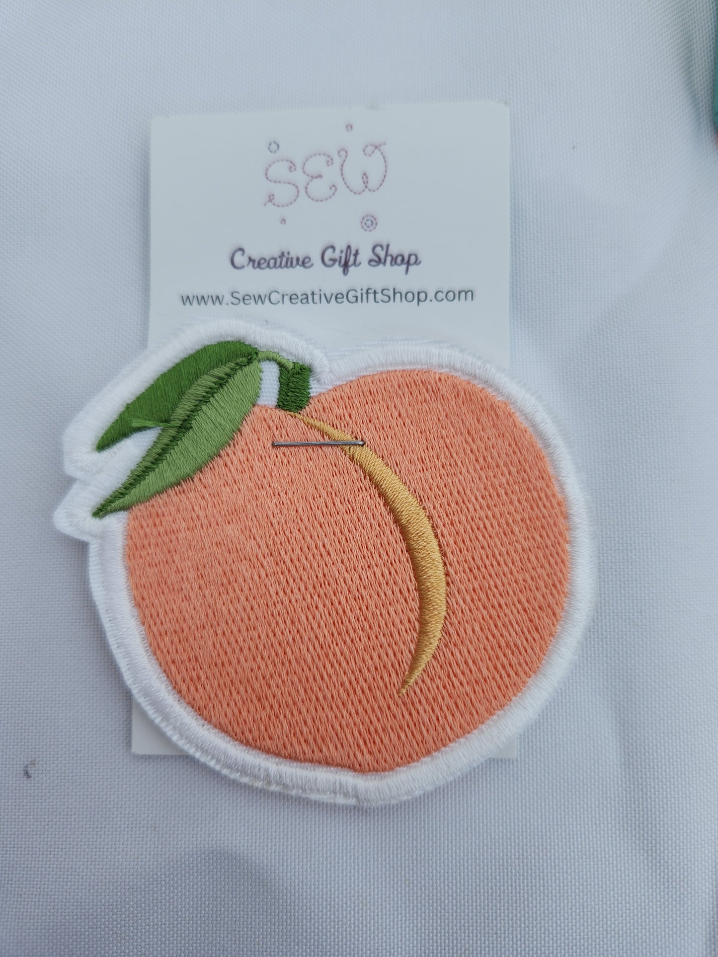 Peach embroidered iron-on patch