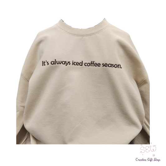 It's always iced coffee season. Sand color Embroidered Adult Sweatshirt